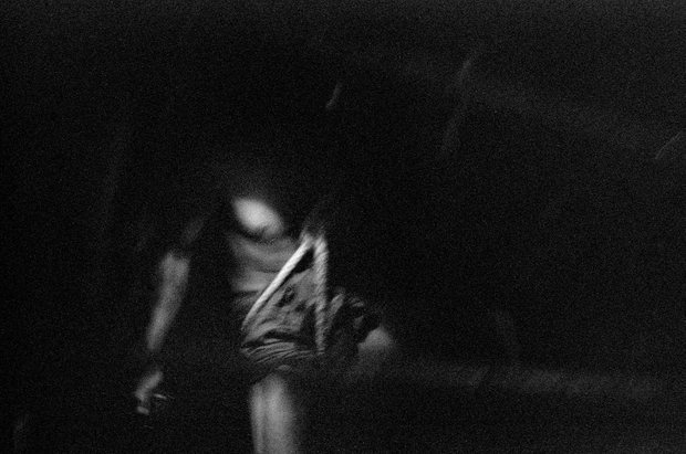 Sintku Township, Mandalay Division, Myanmar, 2013. Wat Tay, 35, readies himself to descend. Because of the heat in the tunnels, he wears very little clothing. Around his waist is a frayed rope harness. He uses an old rag to protect his lungs from dust that clouds the air. © Spike Johnson