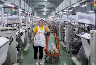 The portrait of female worker at a textile factory in China