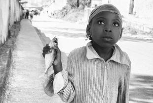 Portrait of little girl with a sardine.