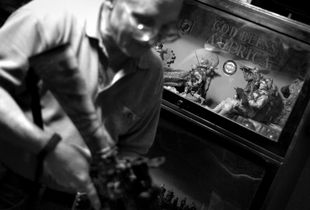 Dallas, Texas, 2010. Harold Rosenbaum, a member of the Texas Survivalists, shows off his collection of assault rifles against the backdrop of his neatly arranged toy soldiers "God I miss that life" he says, as he glances at the display. © Spike Johnson