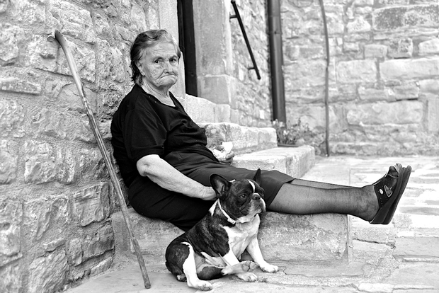An old Lady and a french bulldog in Pietrapertosa (Italy). Hommage to Erwitt.