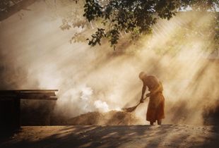 Elderly Monk Burns Leaves at his Monastery in Mae Hong Son City, Thailand.