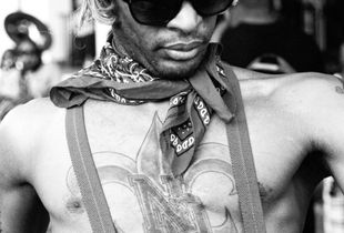 Fleur-de-lis tatooed performer at Jazz Fest