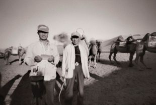 Dunhuang camel herders at Mingsha Shan Sand Dunes (Echoing-Sand Mountain). Near the junction of the Northern and Southern Silk Roads, China