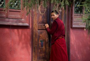 A Mongolian Monk Gives A Watchful Eye At Gandan Monastery