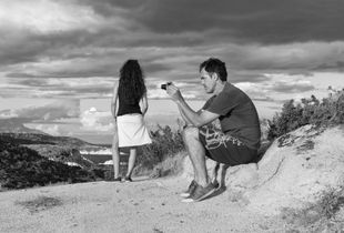 Tourists admiring the evening view on Sithonia peninsula, Greece.