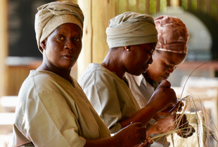 African Ladies Weaving hay