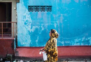A woman walking in the neighbourhood.