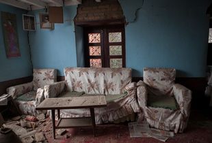 An emty couch and chairs of a destroyed house in Bhaktapur, Nepal