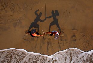 Live shot of two kalaripayat fighters training on the beach in Kozhikode. Kalaripayat is the ancient martial art form from Kerala, said to be older than kung fu. Please note that this pic has NOT been staged AT ALL.