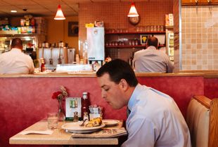 Reading Man in a Diner, New York City 2014