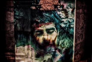 the cemetry of iranian martyrs that killed in iran and iraq war. this place is the biggest cemetry in iran  and includes 33000 martyrs, of whom 4000 are still not identified.The portrait of a martyr on an unknow grave faded by the sunlight over the years.