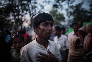 The Rohingya Refugee Crisis. A torn up Rohingya refugee, just arrived on foot from Burma, is waiting in one of the huge camps for water and food supplies. Near Ukhia, Bangladesh.