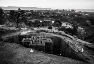 Pilgrims praying at The Church of Saint George, one of eleven rock-hewn monolithic churches in Lalibela, Ethiopia.