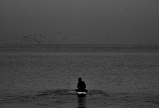 black surfer in solitude