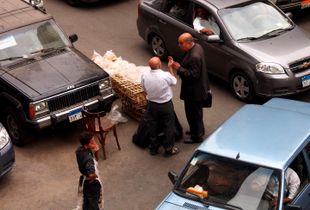 Negotiating about bread's price in the middle of a crossroad
