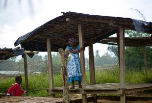 Safe at last: a displaced girl shelters from the rain and attacks in Côte d'Ivoire