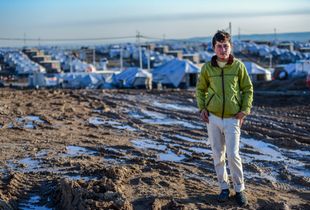 A young Iraqi boy stands at the entrance of his new home - a camp for Internally Displaced Persons in Kurdistan, Iraq.