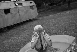 Michael, 8, plays in a kiddie pool. The first time Michael’s mother used meth she went on a five day binge. On the fifth day she woke up to find her oldest son drowning in the bathtub. The boy was resuscitated, but he and Misty’s other children were taken from her care. Michael is the only child who remained in her custody.