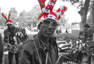 Teenager selling Christmas  decorations, New Delhi.