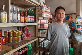 Li lost both of his arms in an industrial accident. Support from the Disabled Persons' Federation allowed him to open a shop, not only providing practical support but also helping him to integrate into the local community.
