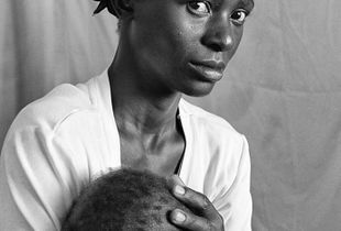 Moments before this image, the pediatrician had told informed this young mother that her child had a fatal heart condition.                                  © Lola Reid Allin
