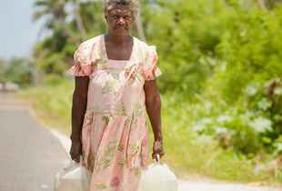 Edna Kalskar, 61 years, collecting water for her home, Eton Village, Efate Island.