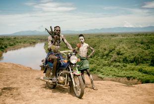 Oyta, his boy, and the village motorbike. Kara tribe, Southern Ethiopia.
