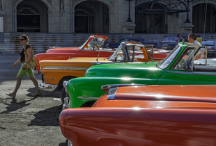 American vintage cars line up in front of the Capitolio building in Havana.