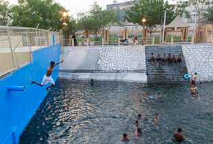 Kids jump from a high spot in the pool