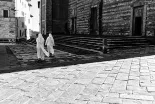 Nuns cross the Piazza Grande