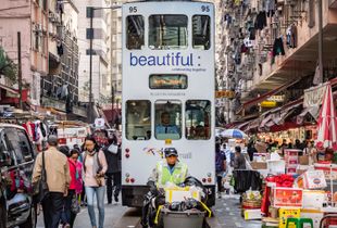 Tram, shoppers and the refuse collector compete for space.