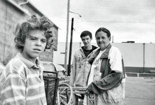 Scrapper family with metal items picked from alleyways arrive at the scrap yard to sell the metal for cash.