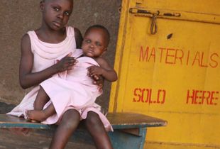 Girl with baby outside school supply store