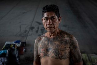 Tijuana, Mexico, November 17th, 2014. Jesus Zuniga, 51, lived in Anaheim, CA, for 32 years and had his own business, a German wife and two children, Jana, 17, and Isaias, 18. He did 20 years in prison for transporting drugs and was deported in 2010 for illegal reentry. He now lives at El Bordo, where he collects clothes, washes them in the river and resells them. He also makes rings and bracelets.