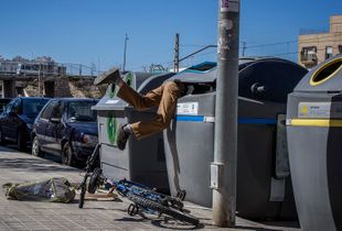 Almeria, Spain. A young North-African immigrant, during his weekly combing of downtown waste containers.