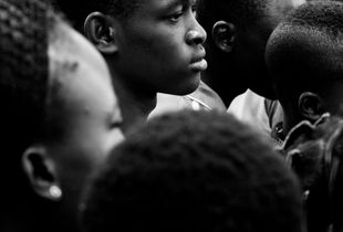 La fête du village - boys in trees and girls in the crowd, waiting for the spectacle to begin in a little village in Burkina Faso.