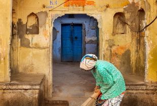 Old woman cleaning the Temple