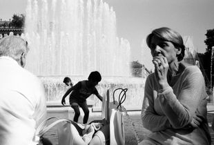 Woman by a fountain with kids