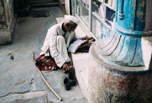 Man immersed in his reading. Madurai.