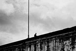 Man stares at the sea from the top of the pier, Ponta Delgada, Azores, Portugal, 2005