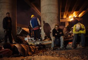 A group of migrants gather beside train tracks under a bridge near to Mexico City where they have to bear the cold at dawn and be alert when train is getting close, in State of Mexico, Mexico, September 20, 2008.