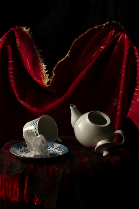 Still-life with drapery, porcelain, and loose-leaf