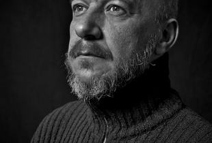 Portrait of a man with a turtleneck sweater.
