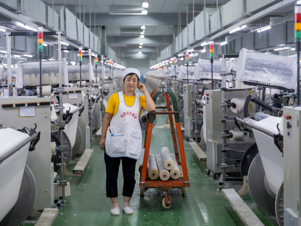 The portrait of female worker at a textile factory in China