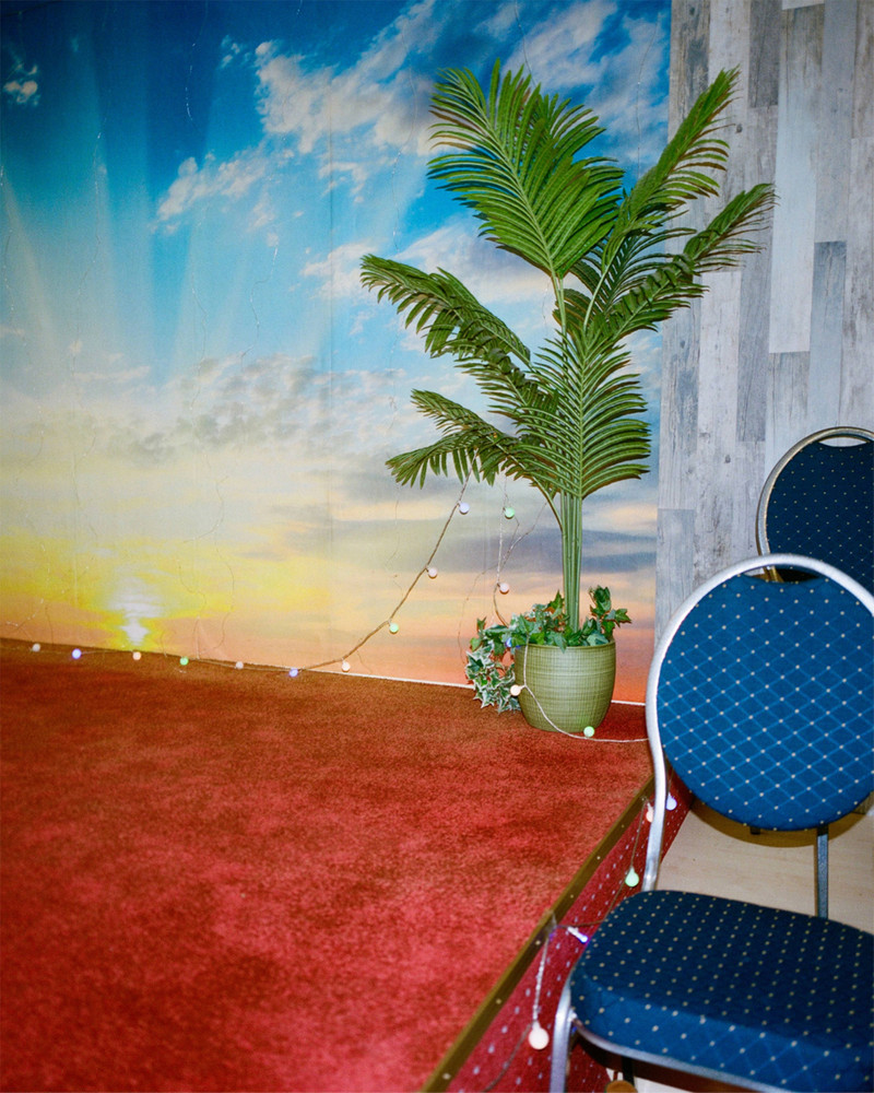 Untitled. On the outskirts of Frankfurt, an industrial area transforms every Sunday as diverse faith communities find solace in affordable, quiet spaces. Hidden within plain warehouses, independent churches and cultural associations thrive, hosting prayers, weddings, and gatherings. Surrounded by office buildings, repair shops and one of Germany's largest meat producing factories, these small communities remain unnoticed by much of the city. In contrast to prominent institutionalized churches, they quietly foster connection and tradition among themselves. © Josefine Rauch