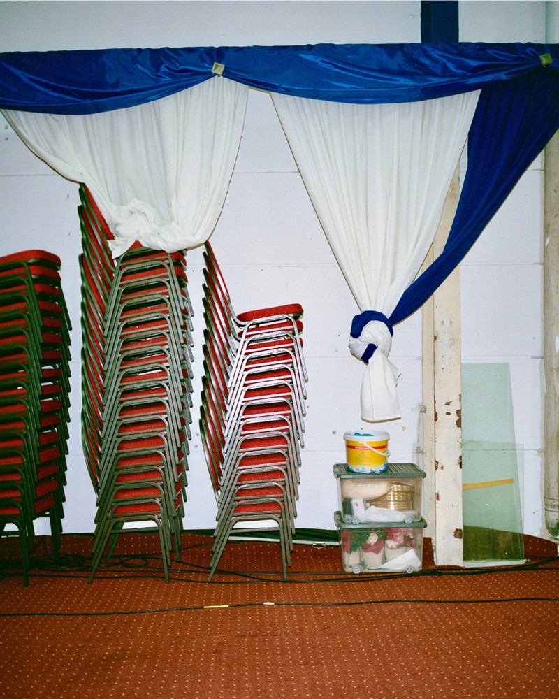 Untitled. On the outskirts of Frankfurt, an industrial area transforms every Sunday as diverse faith communities find solace in affordable, quiet spaces. Hidden within plain warehouses, independent churches and cultural associations thrive, hosting prayers, weddings, and gatherings. Surrounded by office buildings, repair shops and one of Germany's largest meat producing factories, these small communities remain unnoticed by much of the city. In contrast to prominent institutionalized churches, they quietly foster connection and tradition among themselves. © Josefine Rauch