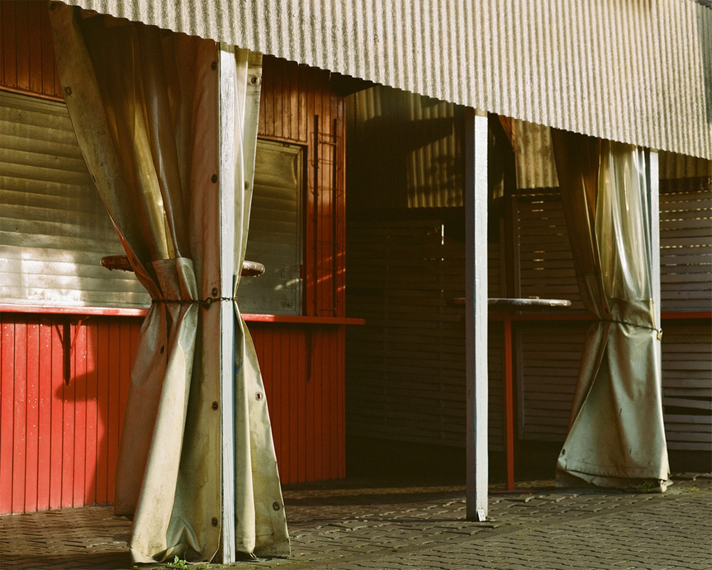 Untitled. On the outskirts of Frankfurt, an industrial area transforms every Sunday as diverse faith communities find solace in affordable, quiet spaces. Hidden within plain warehouses, independent churches and cultural associations thrive, hosting prayers, weddings, and gatherings. Surrounded by office buildings, repair shops and one of Germany's largest meat producing factories, these small communities remain unnoticed by much of the city. In contrast to prominent institutionalized churches, they quietly foster connection and tradition among themselves. © Josefine Rauch