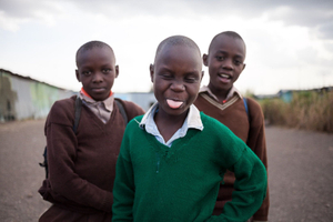 Sinai slum, Nairobi, KENYA, 29.10.2013: School children play during a break at Jobenpha Community school. Some of the ex pupils have made it to university and are now working as engineers, showing the kids that there is a way for them to make it out of the slums through education.