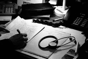 David Dorman, working into the night on patients notes in his GP partnership in Keady, NI. 1998